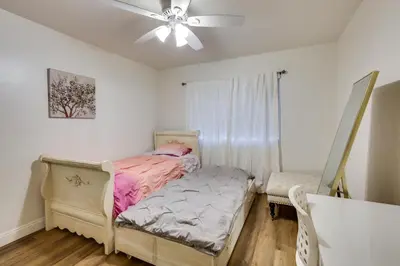 a bedroom with a bed and a ceiling fan at Spacious Home with Yard about 7 Mi to Dtwm San Diego! in San Diego