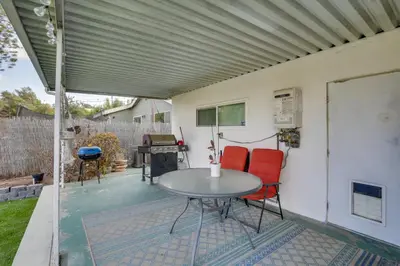 a patio with a table and chairs and a grill at Spacious Home with Yard about 7 Mi to Dtwm San Diego! in San Diego