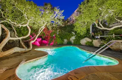 a pool in a garden with trees and flowers at Brooks Beach Vacations Bungalow B116 Oceanside in Oceanside