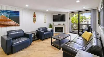 a living room with a couch and chairs and a television at Brooks Beach Vacations Bungalow B116 Oceanside in Oceanside