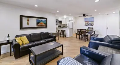 a living room with two couches and a kitchen at Brooks Beach Vacations Bungalow B116 Oceanside in Oceanside