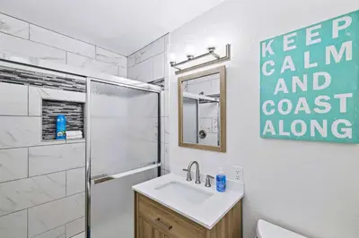 a bathroom with a toilet sink and a shower at Brooks Beach Vacations Bungalow B116 Oceanside in Oceanside