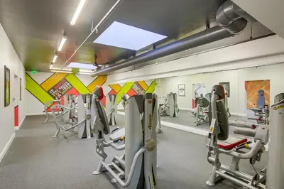 a gym with treadmills and machines in a room at Brooks Beach Vacations Villa C205 Oceanside in Oceanside