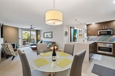 a kitchen and living room with a table and chairs at Brooks Beach Vacations Villa C205 Oceanside in Oceanside