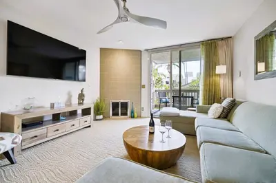 a living room with a couch and a tv at Brooks Beach Vacations Villa C205 Oceanside in Oceanside