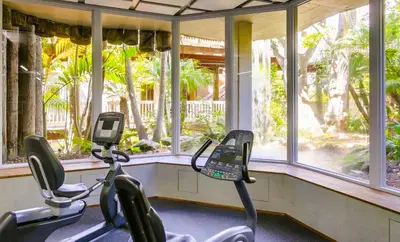 two exercise bikes in a gym with windows at Brooks Beach Vacations House B222 Oceanside in Oceanside
