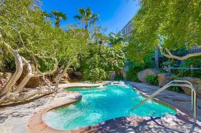 a pool in the middle of a yard with trees at Brooks Beach Vacations House B222 Oceanside in Oceanside