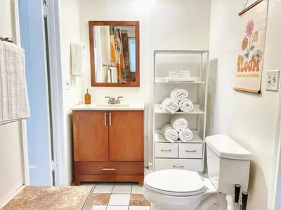 a bathroom with a toilet and a sink and a mirror at Groovy Getaway Retro Vibes in North Park, SD in San Diego