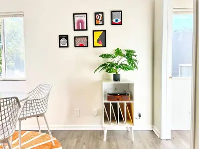 a room with a table and a plant on a wall at Groovy Getaway Retro Vibes in North Park, SD in San Diego