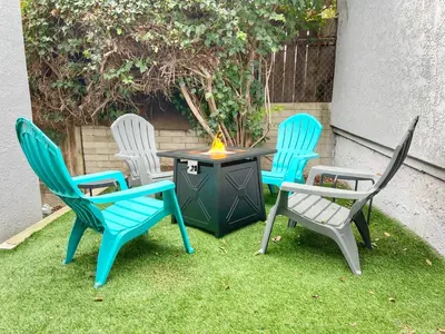 a group of four chairs around a table with a fire pit at Groovy Getaway Retro Vibes in North Park, SD in San Diego