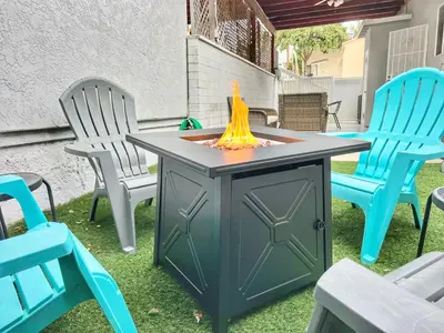 a fire pit in a yard with two chairs at Groovy Getaway Retro Vibes in North Park, SD in San Diego