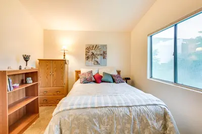 a bedroom with a bed and a large window at Peaceful El Cajon Vacation Rental with Patio and Yard! in El Cajon