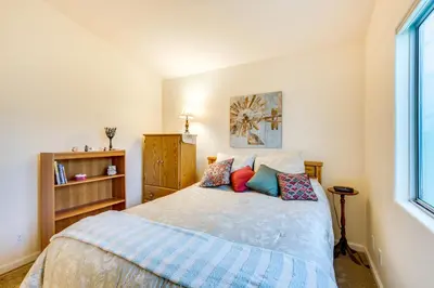 a bedroom with a bed with pillows and a window at Peaceful El Cajon Vacation Rental with Patio and Yard! in El Cajon