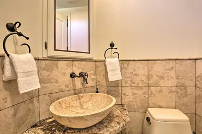 a bathroom with a sink and a toilet at Charming Temecula Home with Hot Tub, Mountain Views! in Temecula