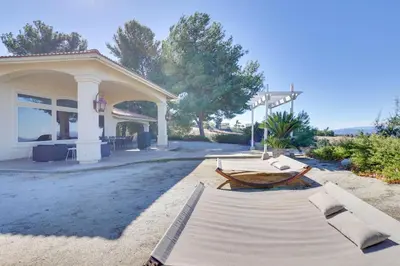 a building with a table and benches in front of it at Charming Temecula Home with Hot Tub, Mountain Views! in Temecula