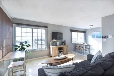 a living room with a couch and a table at Spacious Ocean View Blufftop Compound in San Clemente