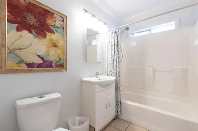 a bathroom with a toilet and a shower and a sink at Spacious Ocean View Blufftop Compound in San Clemente