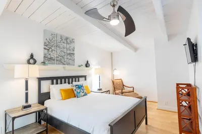 a bedroom with a large bed and a white ceiling at Spacious Ocean View Blufftop Compound in San Clemente