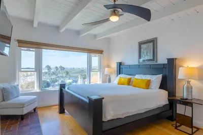 a bedroom with a large bed and a window at Panoramic Ocean View Cottage and Hideaway Unit #4 and B in San Clemente