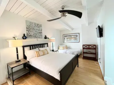 a bedroom with two beds and a ceiling fan at Panoramic Ocean View Cottage and Hideaway Unit #4 and B in San Clemente