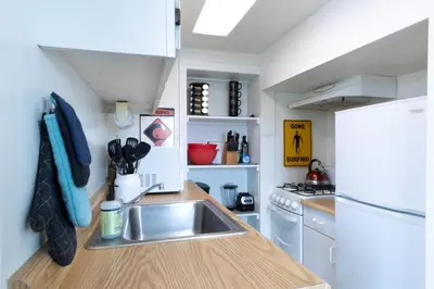 a small kitchen with a sink and a refrigerator at Panoramic Ocean View Cottage and Hideaway Unit #4 and B in San Clemente