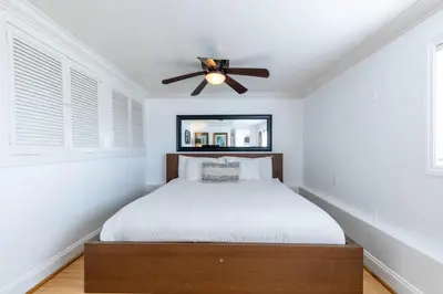 a bedroom with a bed and a ceiling fan at Panoramic Ocean View Cottage and Hideaway Unit #4 and B in San Clemente