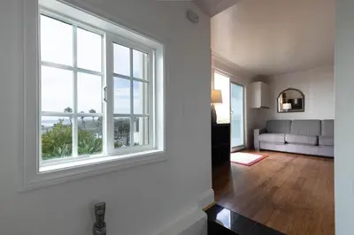 a living room with a window and a couch at Panoramic Ocean View Cottage and Hideaway Unit #4 and B in San Clemente