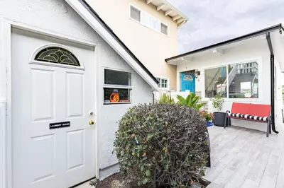 a white house with a white door and a bush at Ocean View Hideaway Unit #3 in San Clemente