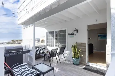 a patio with a grill and chairs and a table at Sea View Escape Unit #2 in San Clemente