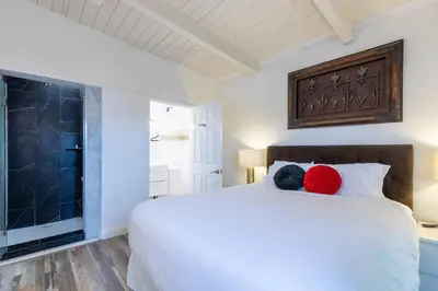 a bedroom with a white bed with two balls of yarn on it at Bright Ocean View Escape Unit #1 in San Clemente