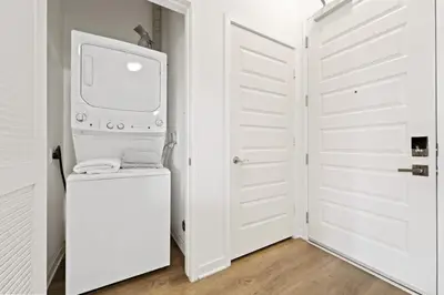 a white laundry room with a washer and dryer at San Diego Stay, Pool, Gym, Near Zoo, Petco Park & SeaWorld in San Diego
