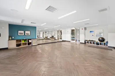 a large room with a hardwood floor in a building at San Diego Stay, Pool, Gym, Near Zoo, Petco Park & SeaWorld in San Diego