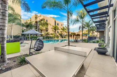 a patio with a table and chairs and a pool at San Diego Stay, Pool, Gym, Near Zoo, Petco Park & SeaWorld in San Diego