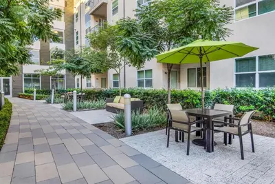 a patio with a table and chairs and an umbrella at San Diego Stay, Pool, Gym, Near Zoo, Petco Park & SeaWorld in San Diego