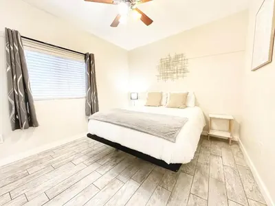 a bedroom with a bed and a ceiling fan at Modern Retreat Just Outside The City in San Diego