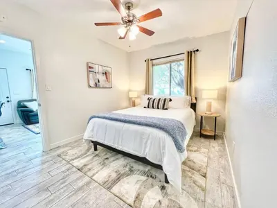 a bedroom with a bed and a ceiling fan at Charming Flat Near the City in San Diego