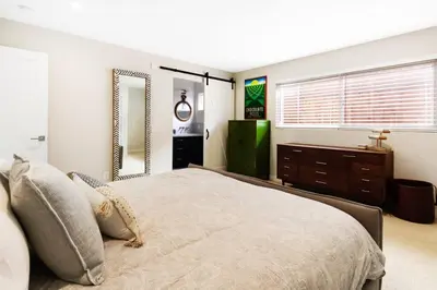 a bedroom with a large bed and a large mirror at The Beachside Hideaway 3 blocks From The Beach! in Encinitas