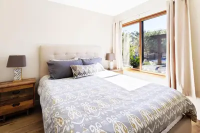 a bedroom with a large bed and a window at The Beachside Hideaway 3 blocks From The Beach! in Encinitas