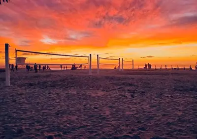 a group of people playing volleyball on the beach at sunset at The Beachside Hideaway 3 blocks From The Beach! in Encinitas