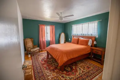 a bedroom with a bed and a ceiling fan at Cozy Home with Downtown View in San Diego