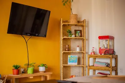 a living room with a flat screen tv on a yellow wall at Cozy Home with Downtown View in San Diego