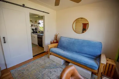 a blue couch in a living room with a kitchen at Cozy Home with Downtown View in San Diego