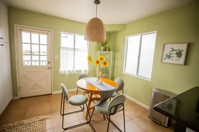 a dining room with a wooden table and chairs at Cozy Home with Downtown View in San Diego