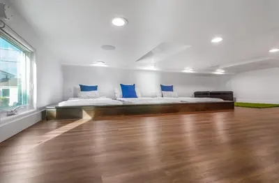 a bedroom with a bed with blue pillows on it at Ocean Dreamin in Encinitas