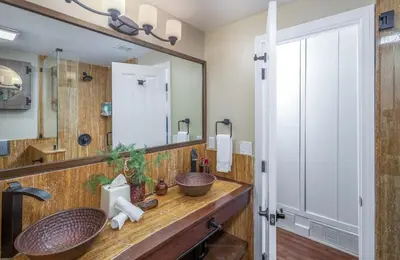a bathroom with a sink and a large mirror at Ocean Dreamin in Encinitas