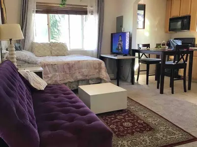 a living room with a purple couch and a table at Min to Downtown/Beach/Parks Free Parking Sleep 3+ in San Diego