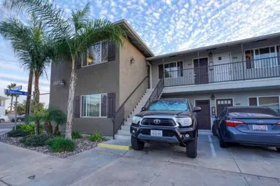 a truck and a car parked in front of a house at Min to Downtown/Beach/Parks Free Parking Sleep 3+ in San Diego
