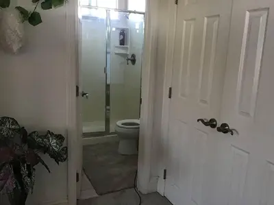 a bathroom with a toilet and a glass shower door at Min to Downtown/Beach/Parks Free Parking Sleep 3+ in San Diego