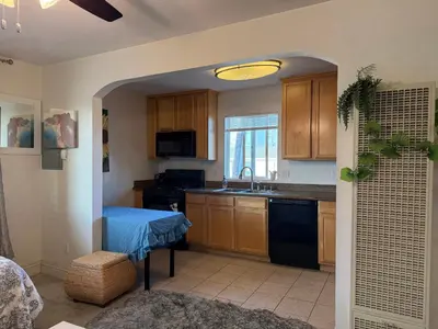 a kitchen with wooden cabinets and a sink at Min to Downtown/Beach/Parks Free Parking Sleep 3+ in San Diego