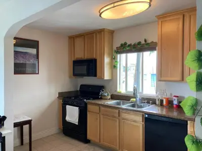 a kitchen with a black stove and a sink at Min to Downtown/Beach/Parks Free Parking Sleep 3+ in San Diego